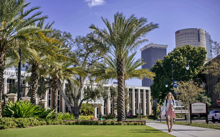 Student walking in front of the Macdonald-Kelce Library